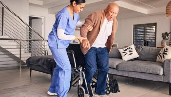 Woman,Helping,Man,In,Wheelchair,,Nursing,Home,And,Medical,Service