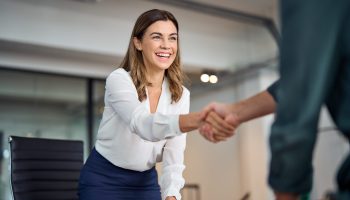 Happy,Mid,Aged,Business,Woman,Manager,Handshaking,Greeting,Client,In