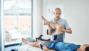Physiotherapy,,Men,And,Client,With,Recovery,,Leg,Pain,And,Healing