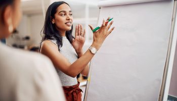 Woman,,Mentor,And,Whiteboard,In,Office,For,Training,,Teaching,And