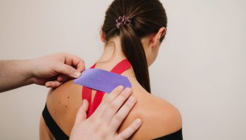 Medical,Tape.,Doctor,Is,Applying,Bright,Kinesiology,Tape,On,Athlete