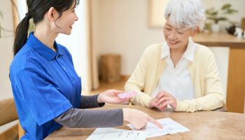 Asian,Caregiver,Assisting,With,Medication,During,Home,Care,Visit